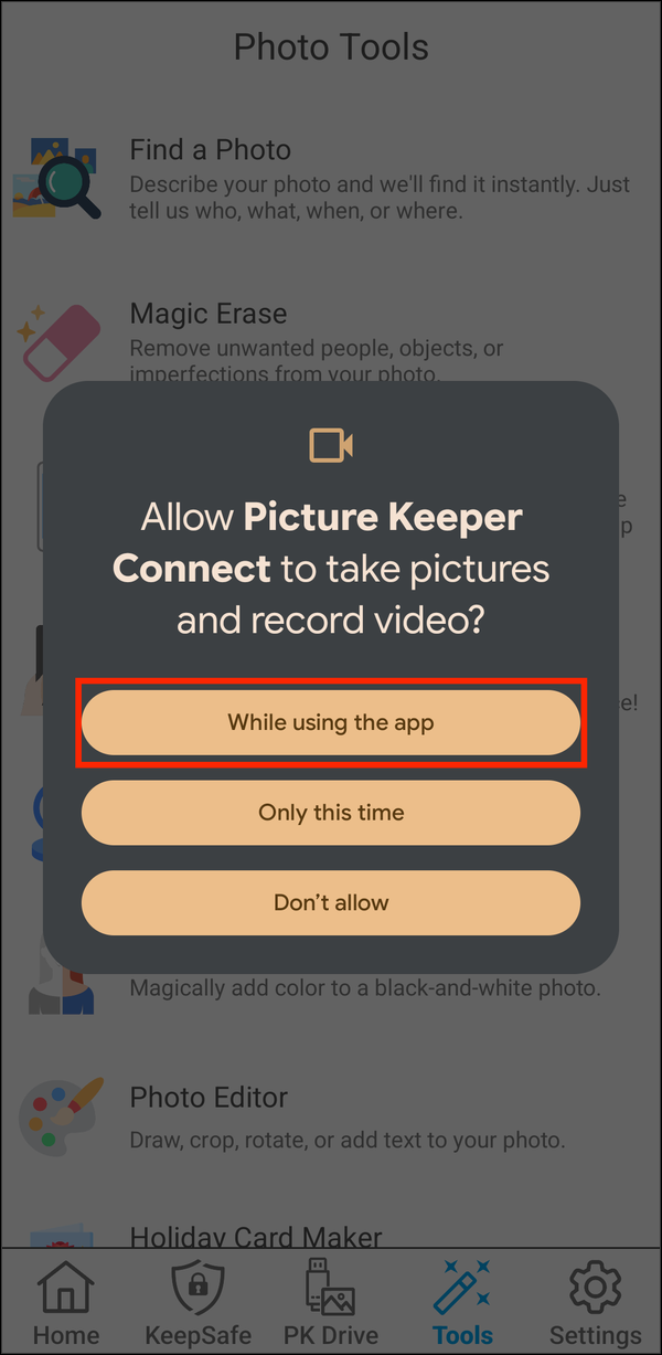 Camera permission prompt with While using the app highlighted